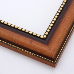 This solid wood, steeply curved frame features a natural, walnut finish that fades into deep brown approaching a gold foil-beaded inner lip.  The outer edge has a slender dashed border in gold foil.

2 " width: ideal for medium images.  Add some elegance to a family portrait, or border an old oil painting or print with this timeless frame.