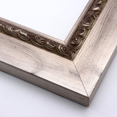 This flat profile, solid wood frame features a high scroll and dot relief design topped with silver leaf, along the inner edge.  The wide surrounding edge mimics brushed silver.

2.5 " width: ideal for larger images.  Highlight a traditional black and white photograph, oil painting or Giclée print.  The extension of the flat outer edge beyond the relief detail ensures the frame will not detract from your image.