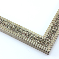 This slim, ornamented design features bevelled inner and outer edges and a celtic cross pattern in relief  The solid wood frame is covered in a gold-brushed silver foil. A faint red patina gives it an antiqued look.

1.25 " width: ideal for smaller artwork.  Photographs, paintings and giclee prints will shine within this detailed frame.