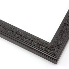 This slim, ornamented design features bevelled inner and outer edges and a celtic cross  pattern in relief.  The solid wood frame is covered in a matte black, while a subtle red patina gives it an antiqued look.

1.25 " width: ideal for smaller artwork.  Photographs, paintings and giclee prints will shine within this detailed frame.