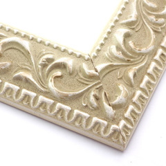 A large, reverse curve profile frame with an intricate leaf design bordered by a geometric outer edge and beaded inner lip.  The cream-colour base features a white patina for added depth on the topmost points of the design. Strong, solid wood construction.

2.75 " width: ideal for large and extra large images.