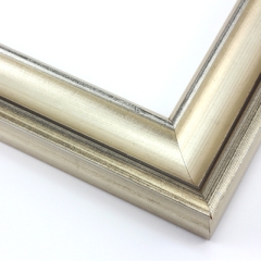 This high fashion, solid wood frame features a dramatic scoop profile and high outer edge (1.25” depth), all wrapped in ornate silver foil.  A black patina applied to the top-most ridges give it a subtle, distressed appearance that adds to its vintage elegance.

2 " width: ideal for medium- or large-size images.  Border an old family photograph, favourite painting, or Giclée print in this quality frame.