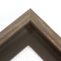 This dark brown floater frame features a 1 " profile and 1 " depth. This simple frame is elevated by the visible natural wood grain.