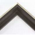 This medium, L-shaped floating contemporary canvas frame in matte black features a thin silver face.