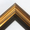 This gold floater frame features a 1" depth and is elegantly enhanced by intricate scooped bevel layering that catches the light beautifully, creating rich and dynamic golden dimension.
