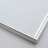 This simple metal picture frame has a bold, high-shine silver finish and curved profile. The outer drop edge has a tiny vertical ridge texture. 

.375 " width: ideal for small, medium or large-size artwork. Easily frame photographs, paintings or drawings on paper, or even Giclée canvas prints.