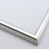 This simple metal picture frame has a high-shine, silver finish and curved profile. 

.875 " width: ideal for small, medium or large artworks. Easily frame photographs, thicker cloth or needlework art, or even Giclée canvas prints.