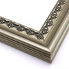 This solid wood frame features a crown moulding profile in a bold, bronze-brushed silver.  The slight distressing on the deeply scooped face and the faint red patina on the delicate inner design give it an antique look that suits old paintings, prints and family photographs alike.

2.5 " width and 1 " high at outer edge: ideal for medium- to large-size images.